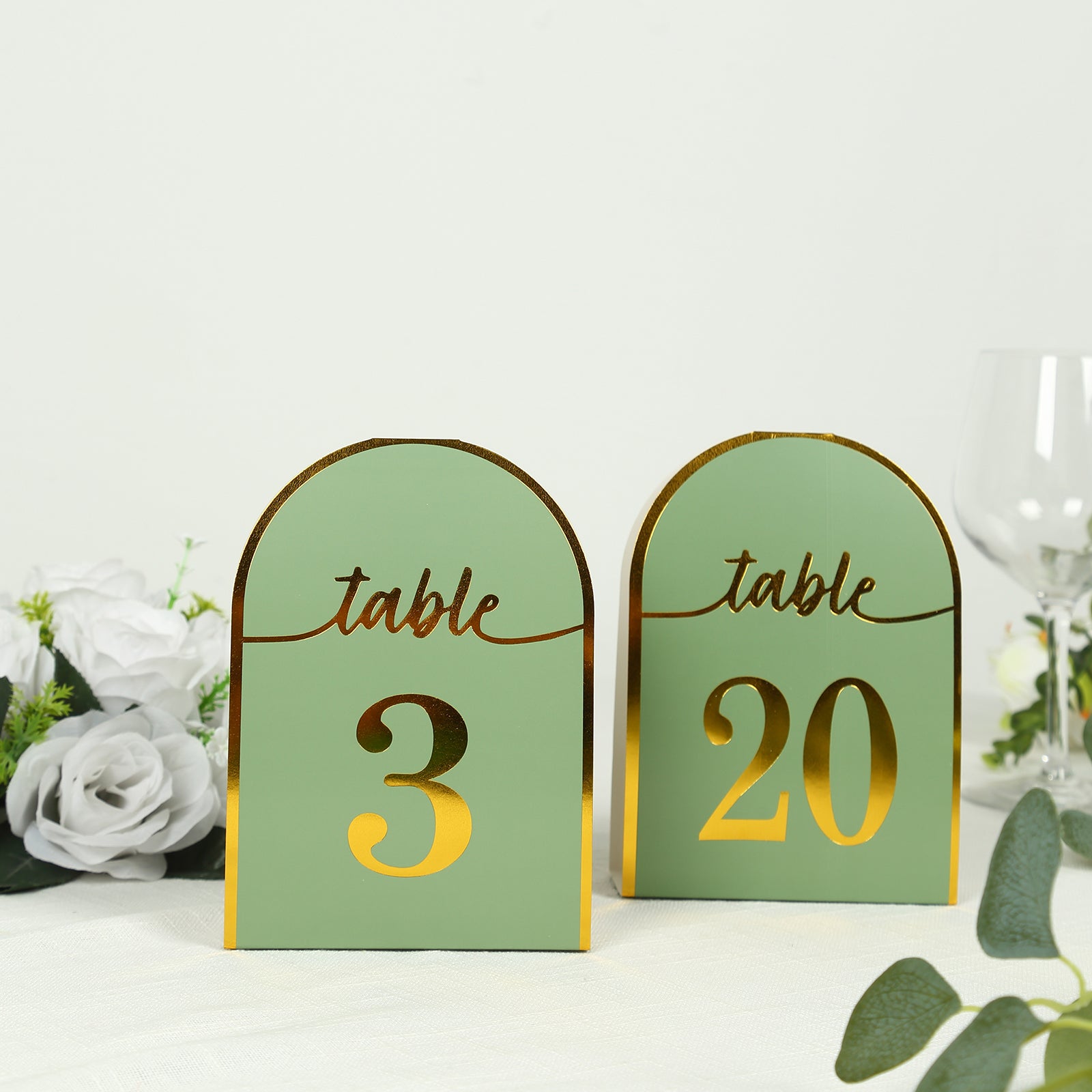 Sage green double-sided table numbers with metallic gold foil numbers.