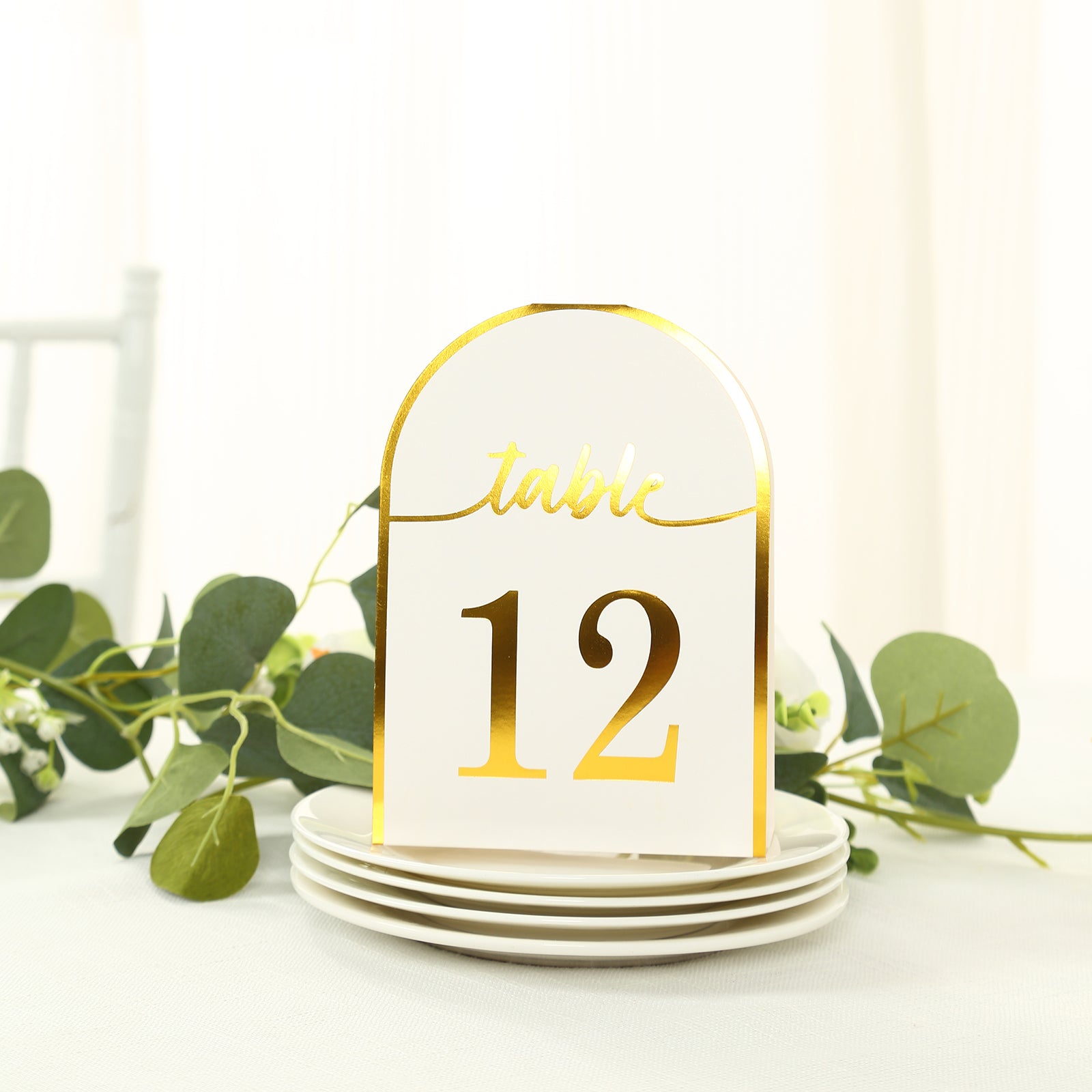 White and gold disposable table number card with metallic foil.