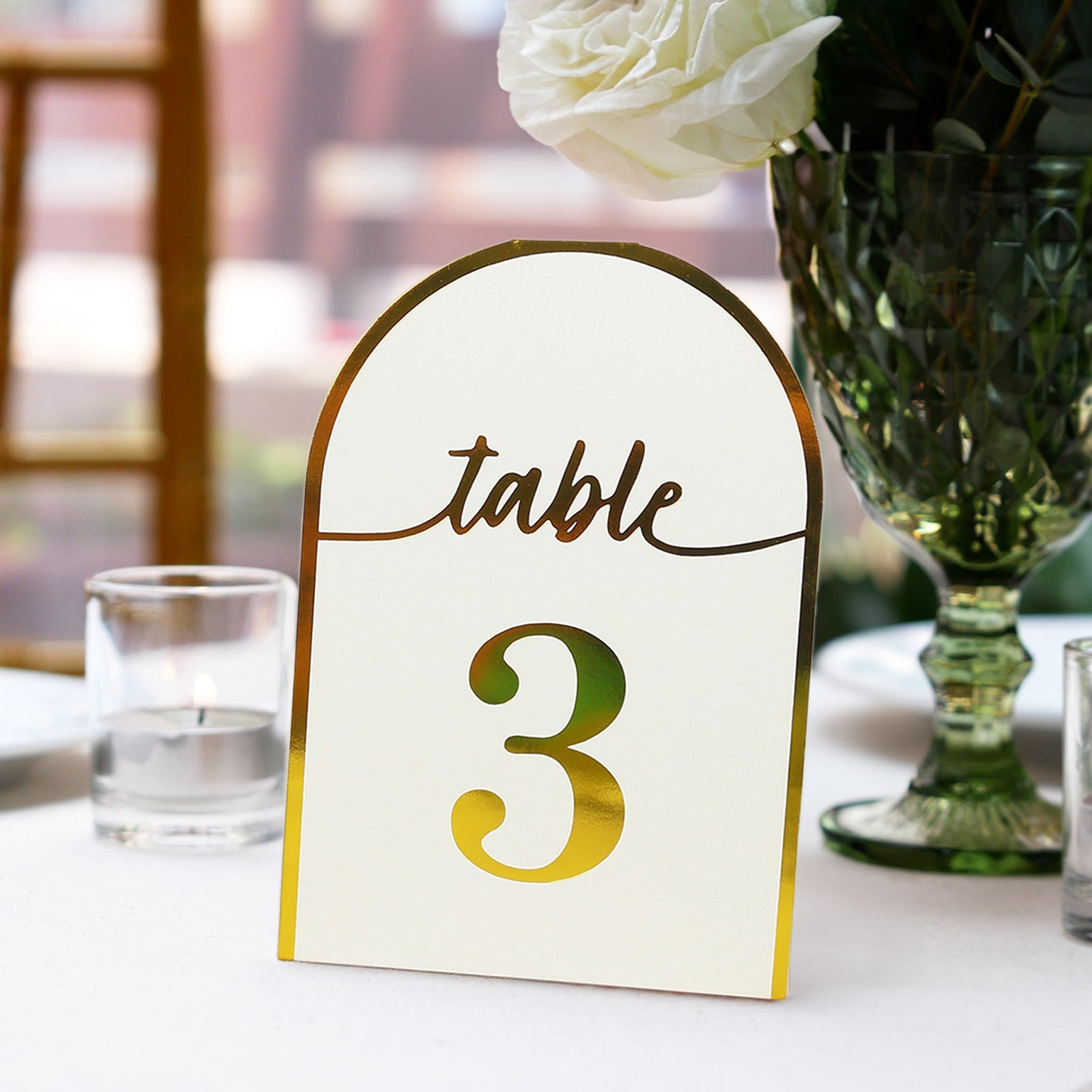 White disposable table number card with metallic gold foil number 3.