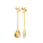 Gold spoon and fork set with leaf-shaped handles, perfect for bridal shower favors.