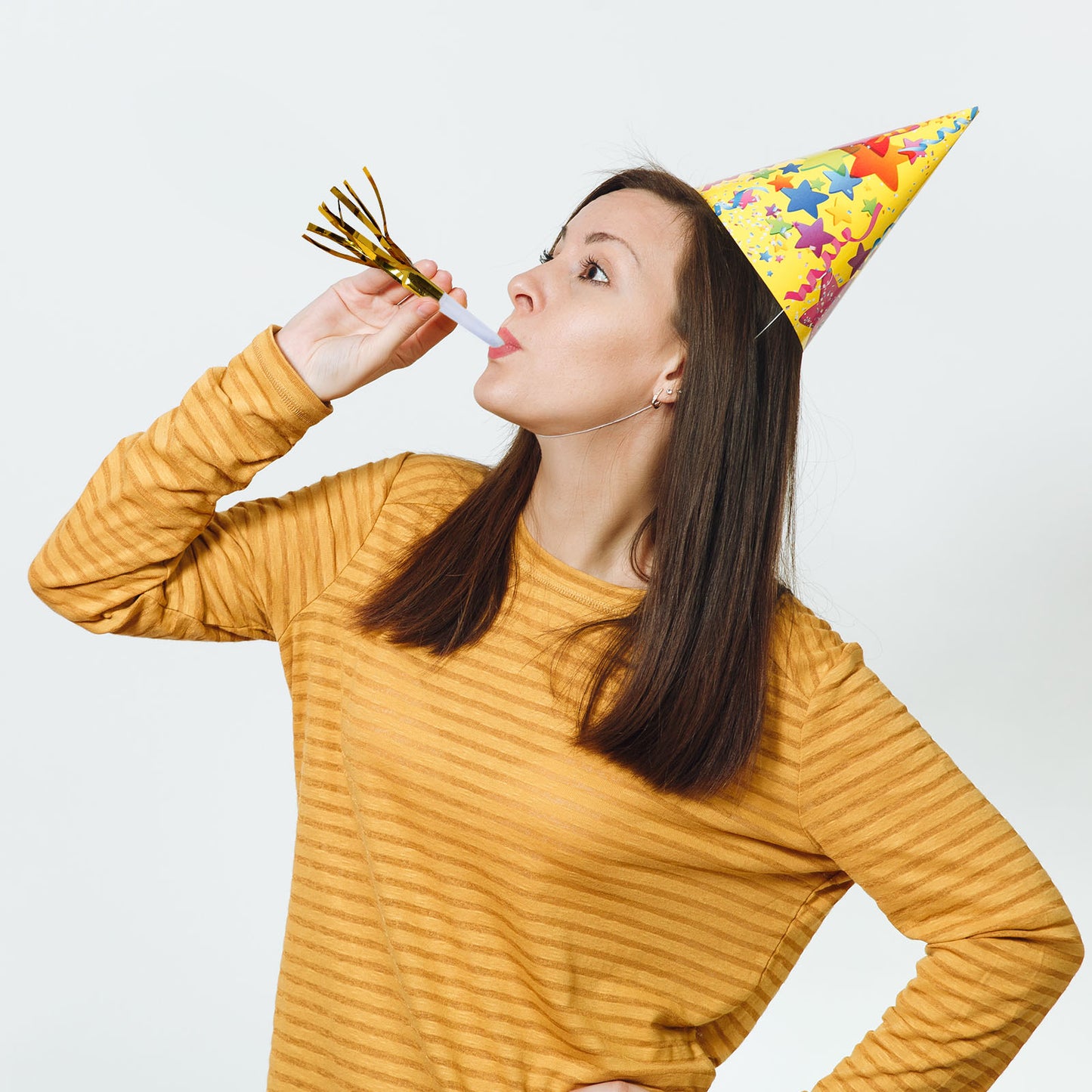 Gold metallic party horn noisemaker with tassels for celebrations.