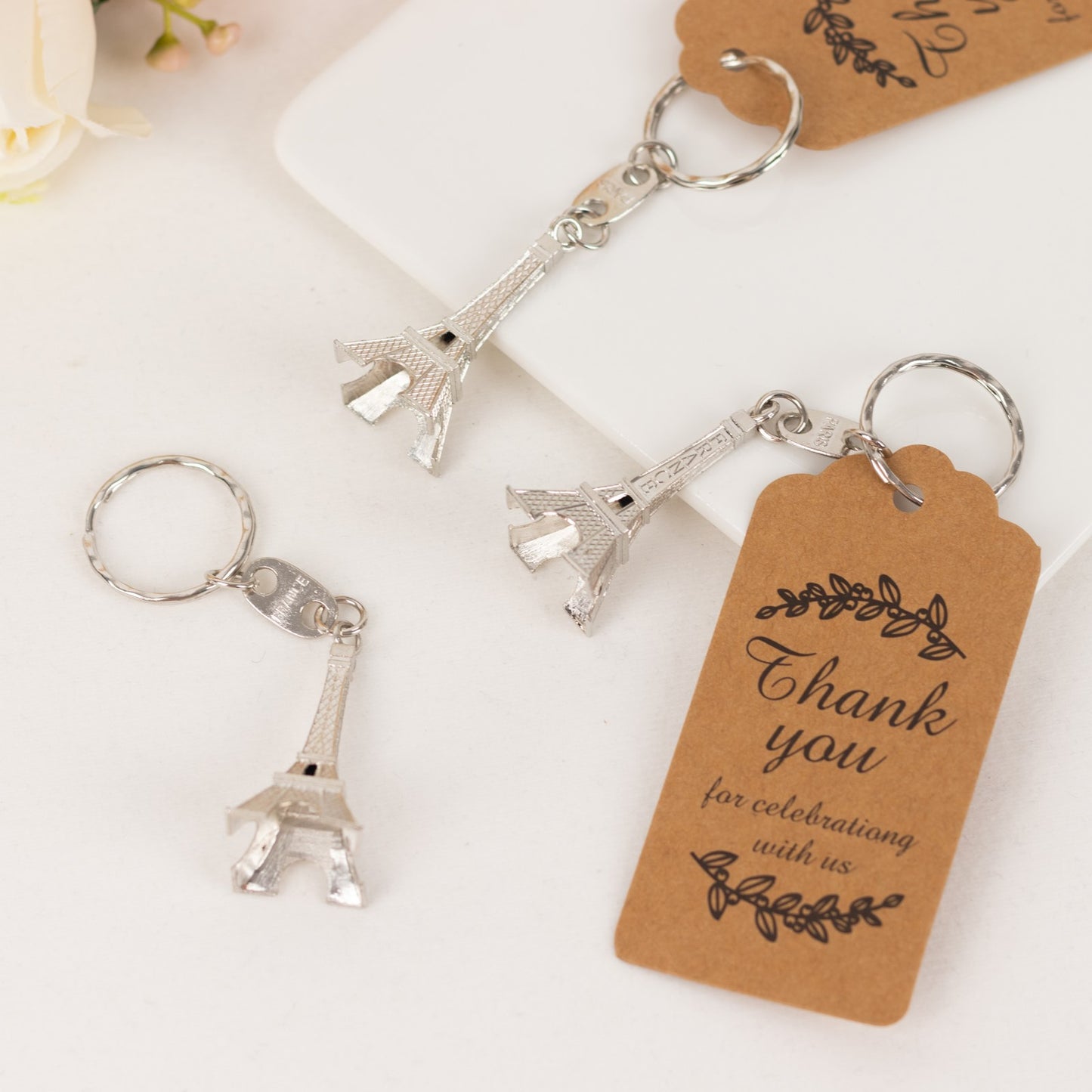 Silver Eiffel Tower keychain wedding favors with thank you tag.