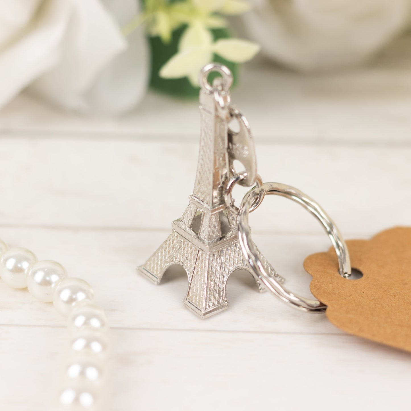 Silver Eiffel Tower keychain wedding favor with thank you tag.