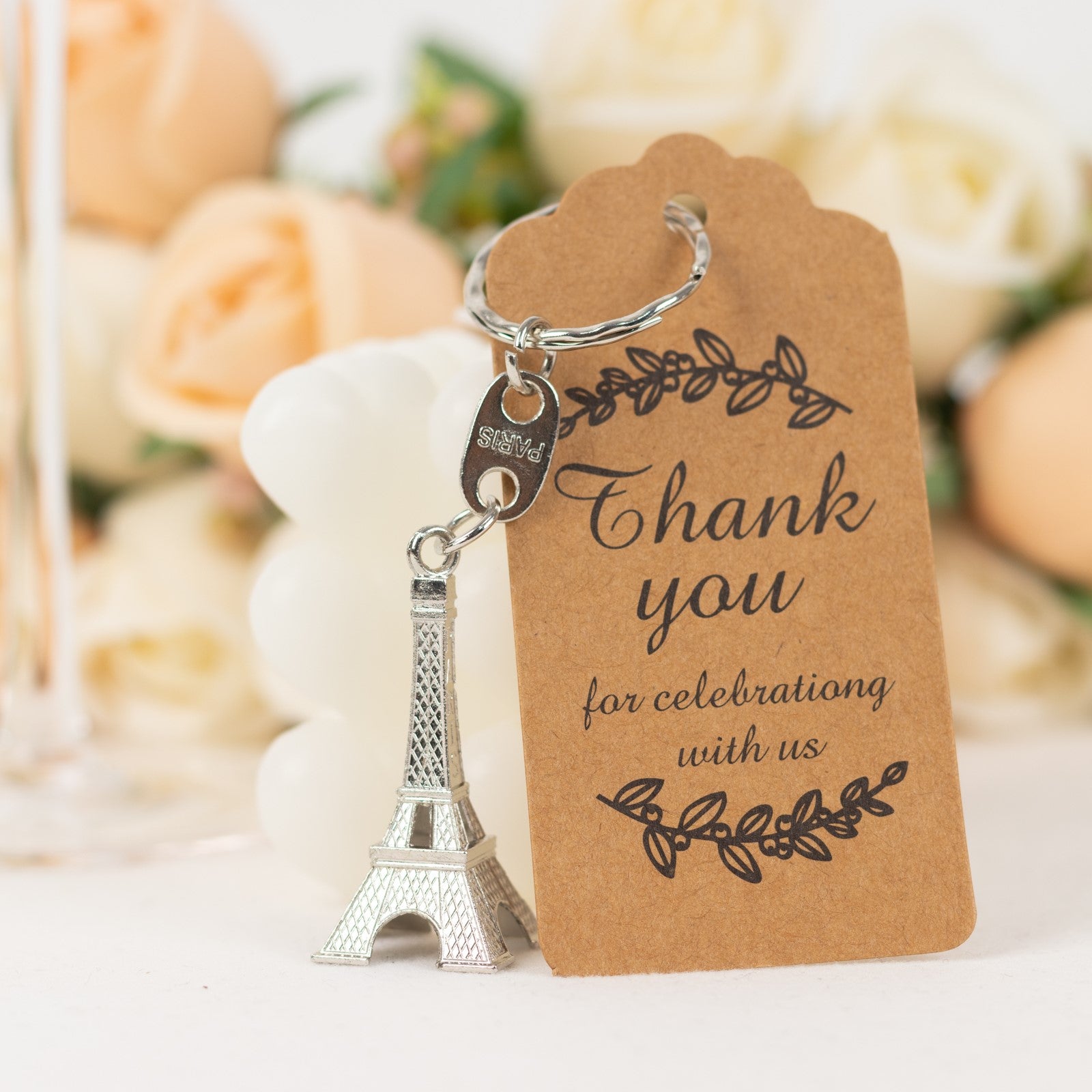 Silver Eiffel Tower keychain wedding favor with thank you tag.