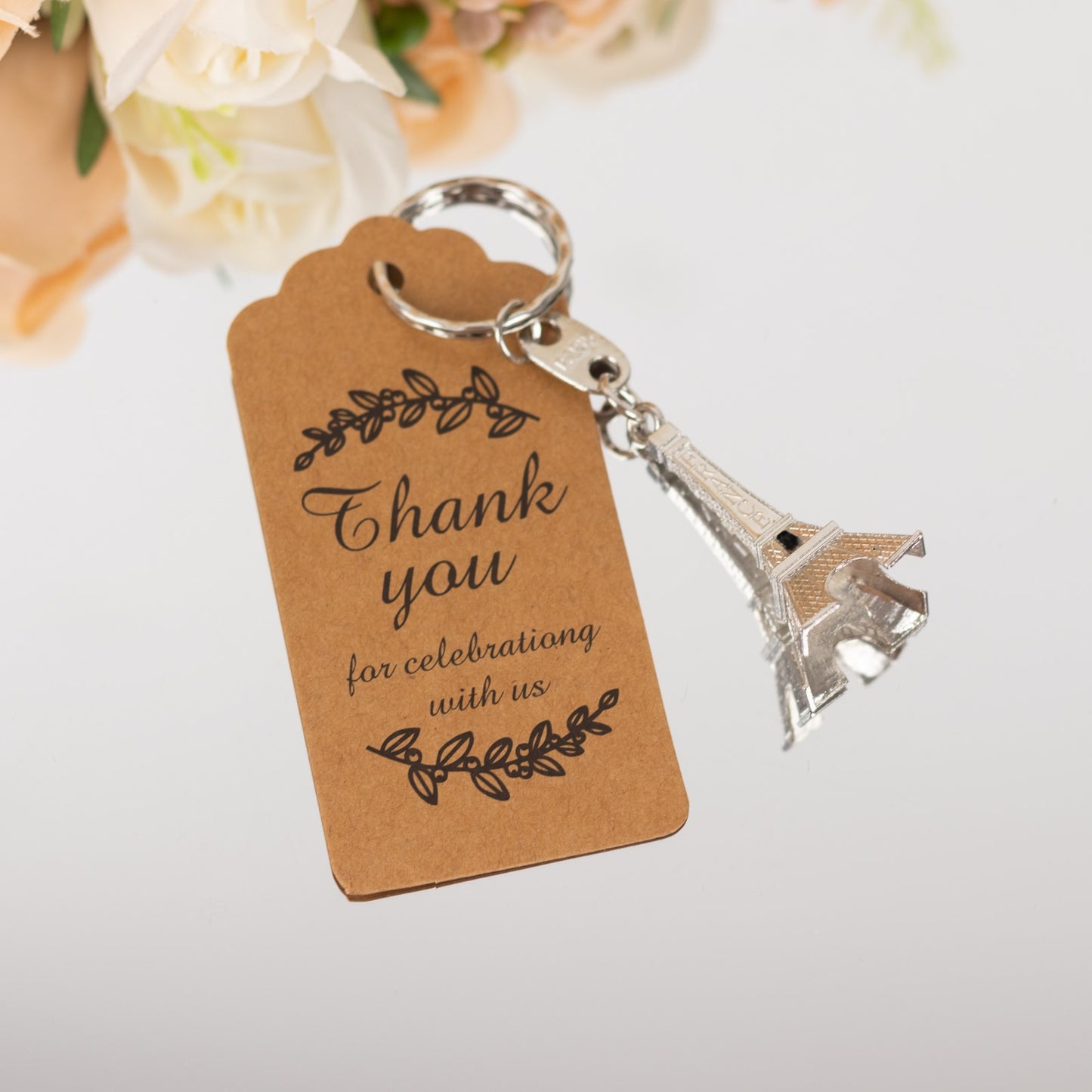 Silver Eiffel Tower keychain with thank you tag for wedding favors.