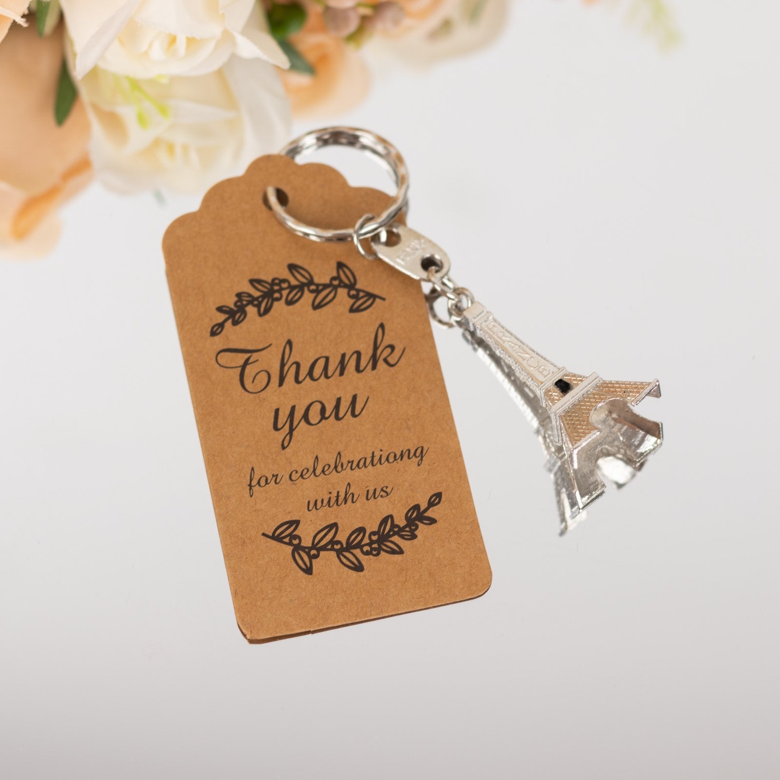 Silver Eiffel Tower keychain with thank you tag for wedding favors.