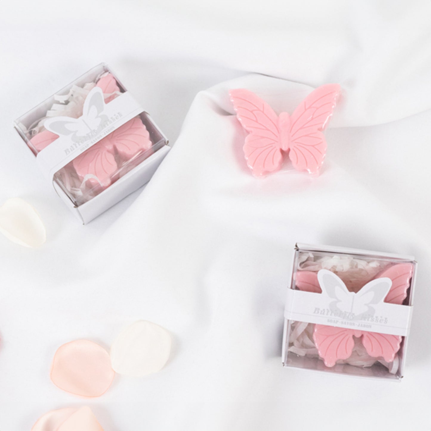Blush butterfly soap favors in gift boxes for baby shower.