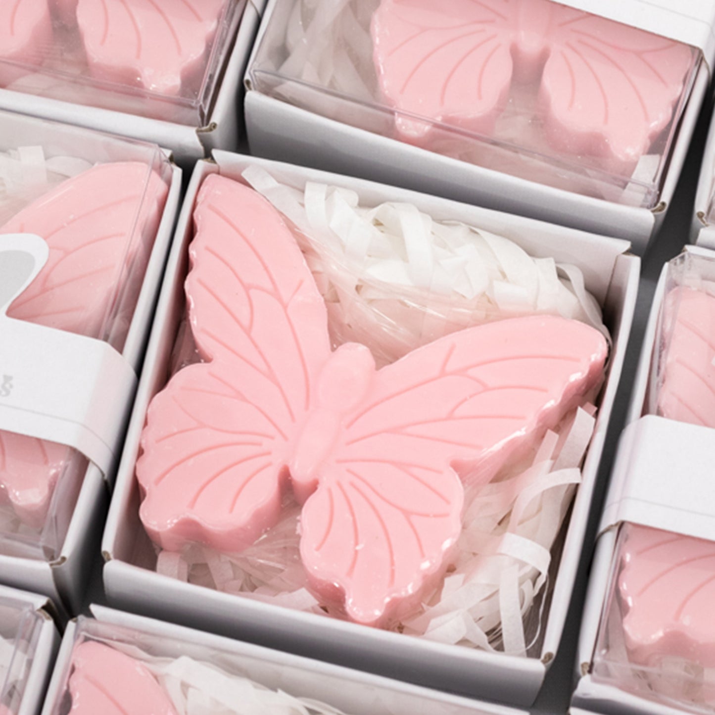 Blush pink butterfly soap favors in gift boxes for baby shower.