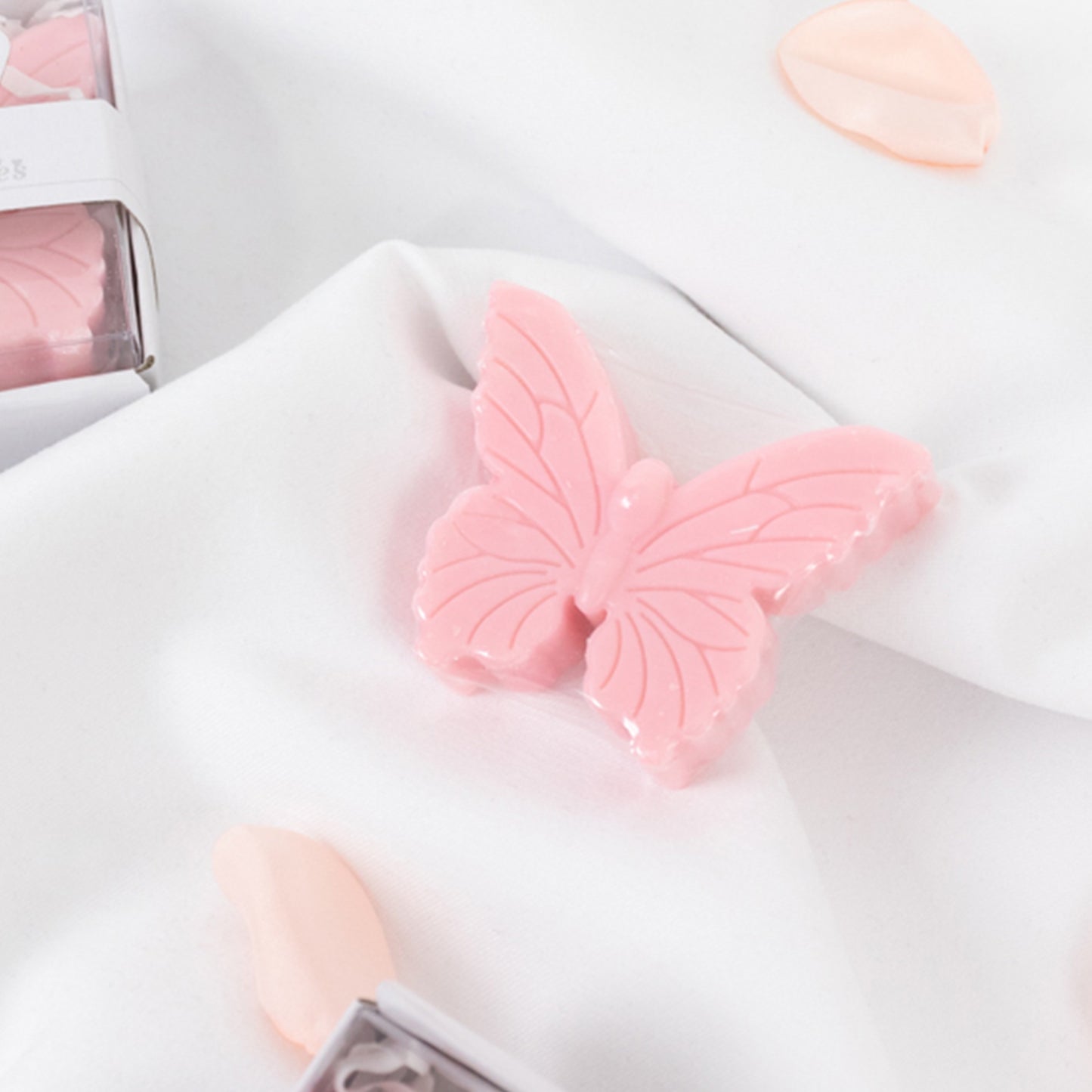Blush pink butterfly soap baby shower favors in gift boxes.