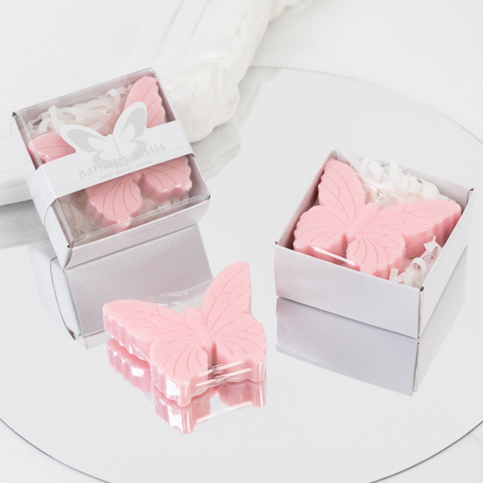 Blush butterfly soap favors in gift boxes for baby shower or wedding souvenirs.