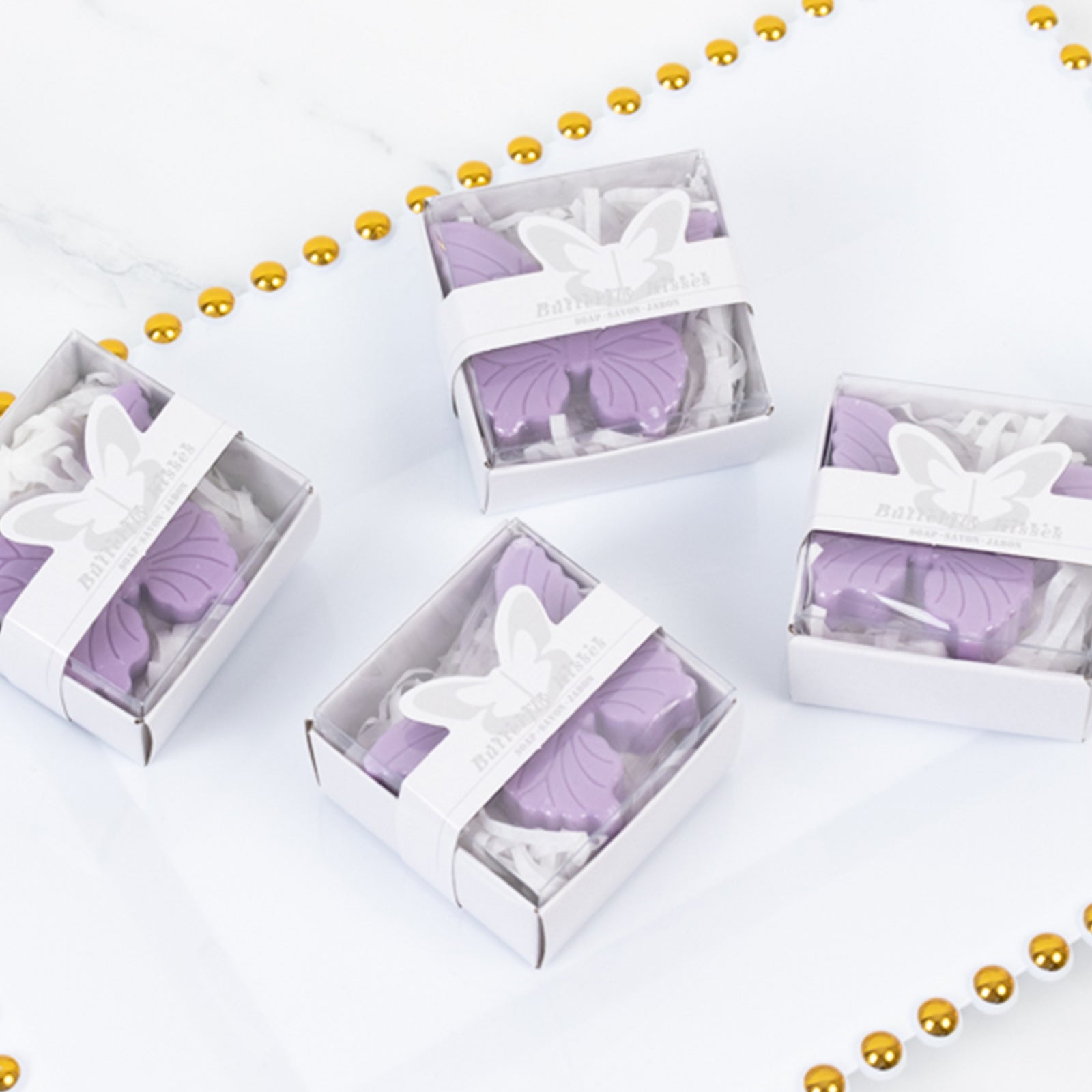 Lavender butterfly soap favors in gift boxes for baby showers.