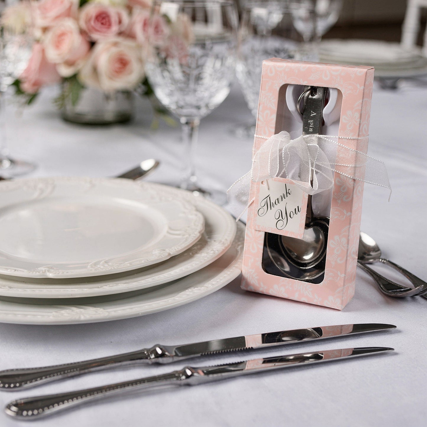 Engraved silver heart measuring spoon set in a decorative gift box.