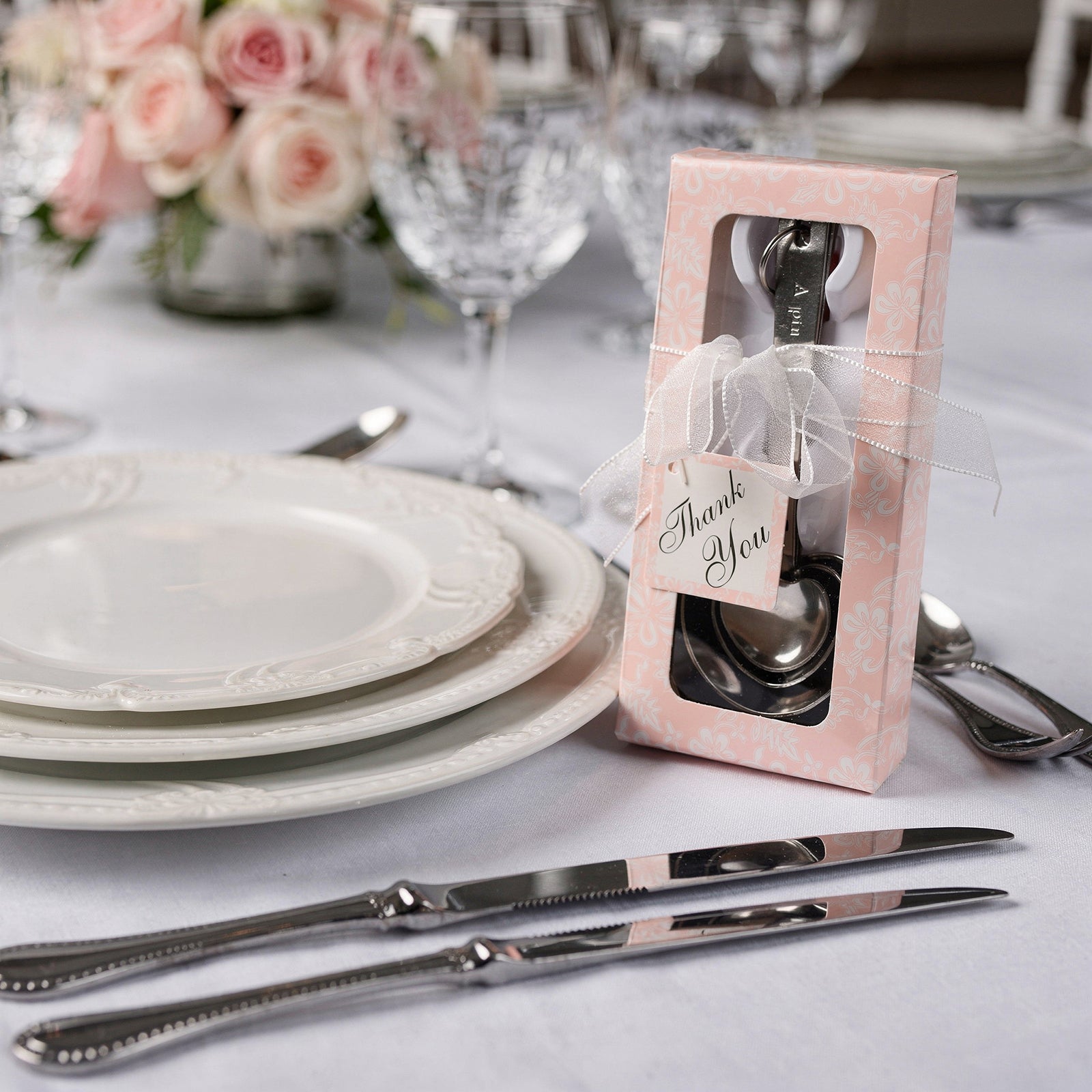 Engraved silver heart measuring spoon set in a decorative gift box.