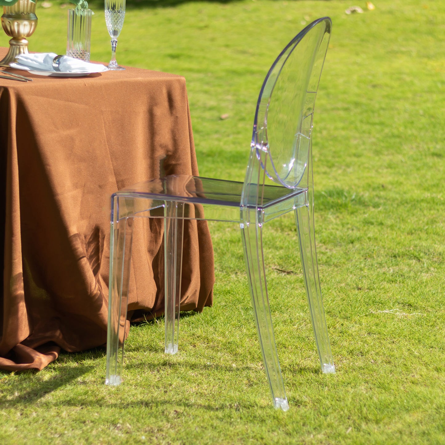 Clear acrylic ghost banquet chair with oval back, stackable and armless.