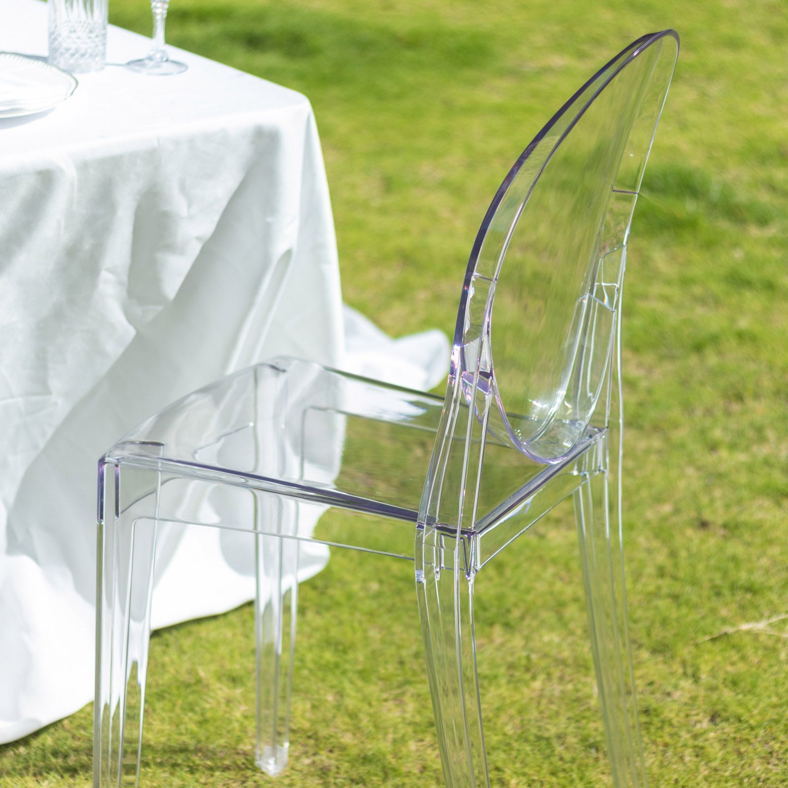 Clear acrylic ghost banquet chair with oval back, fully assembled.