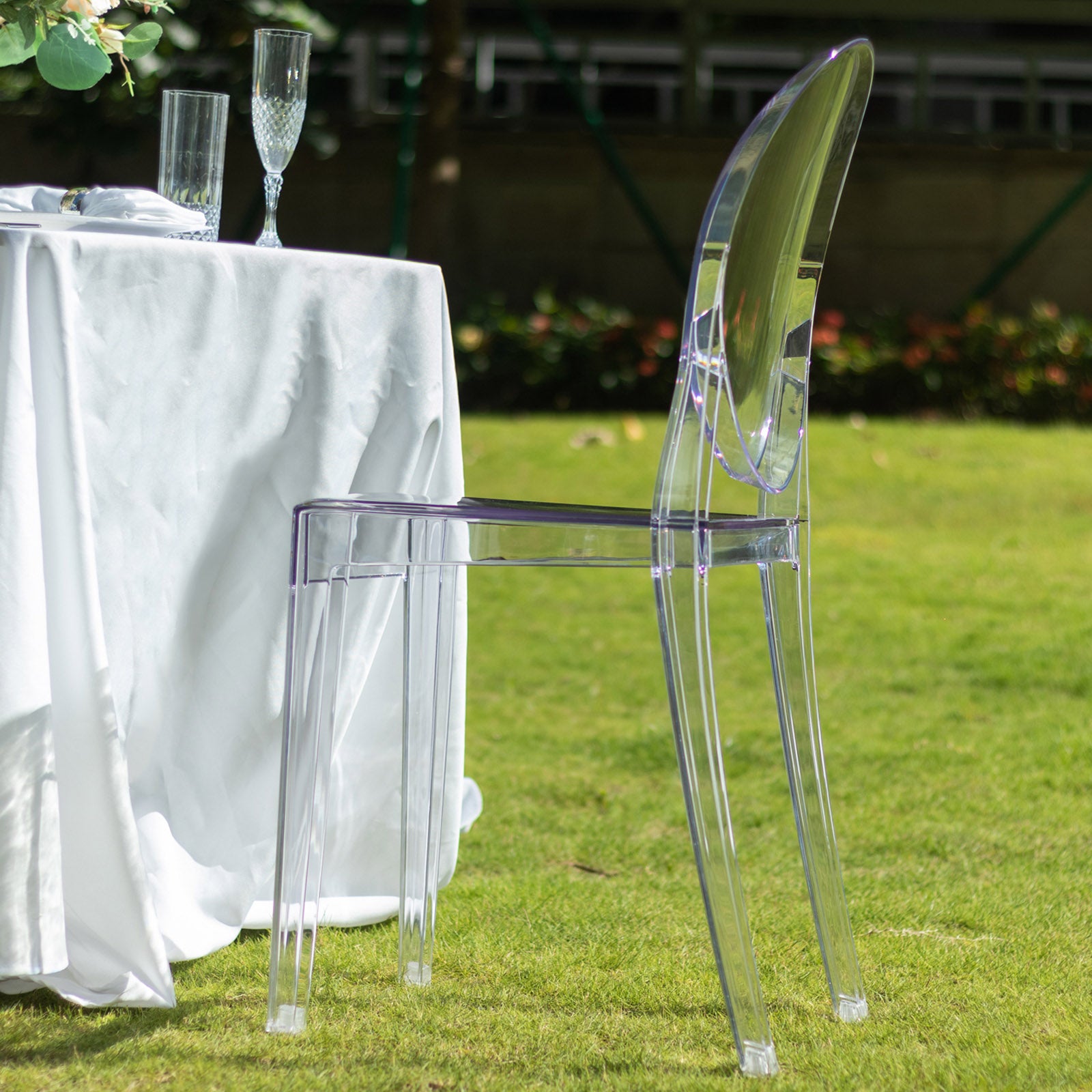 Clear acrylic ghost banquet chair with oval back, fully assembled and armless.