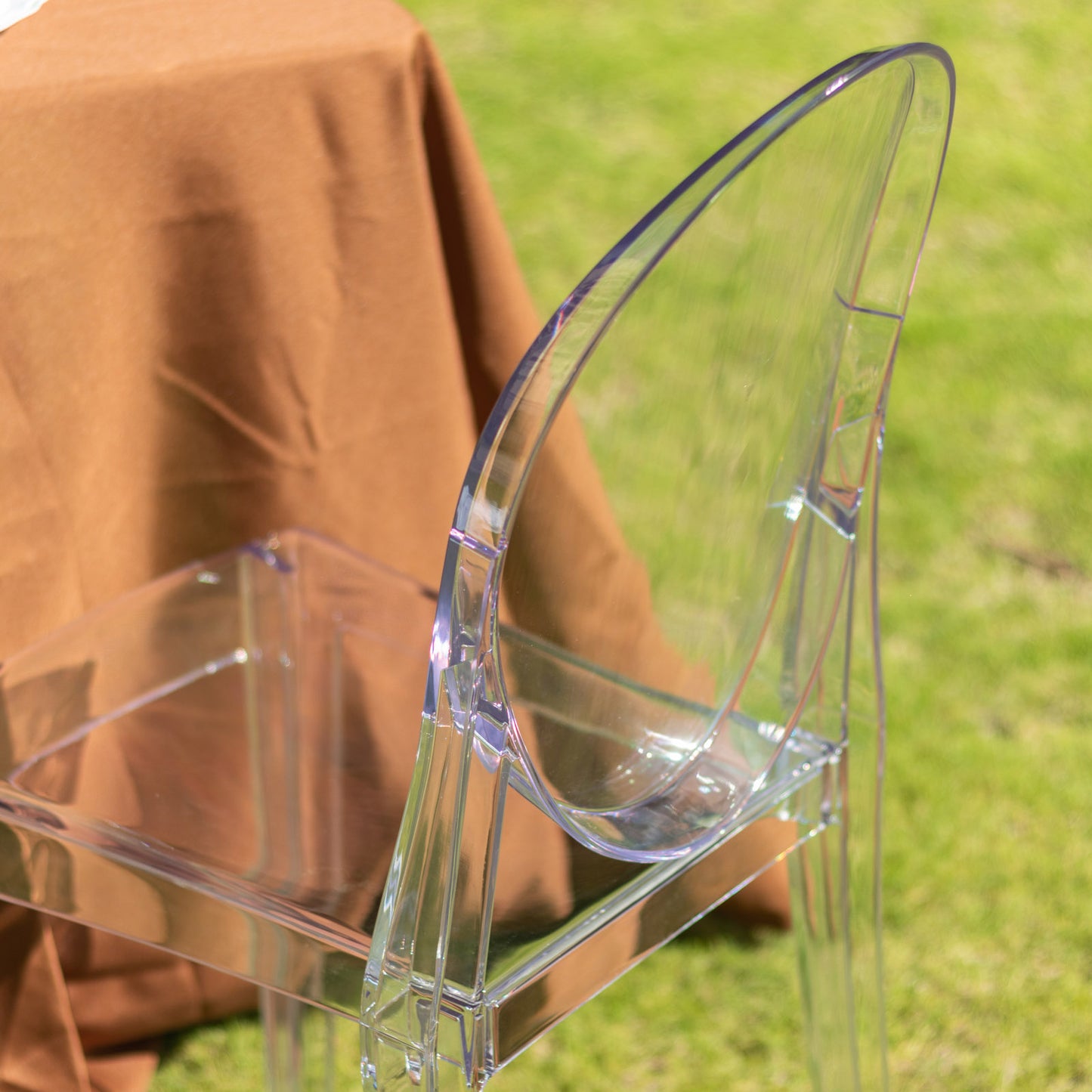 Clear acrylic ghost banquet chair with oval back, fully assembled and armless.