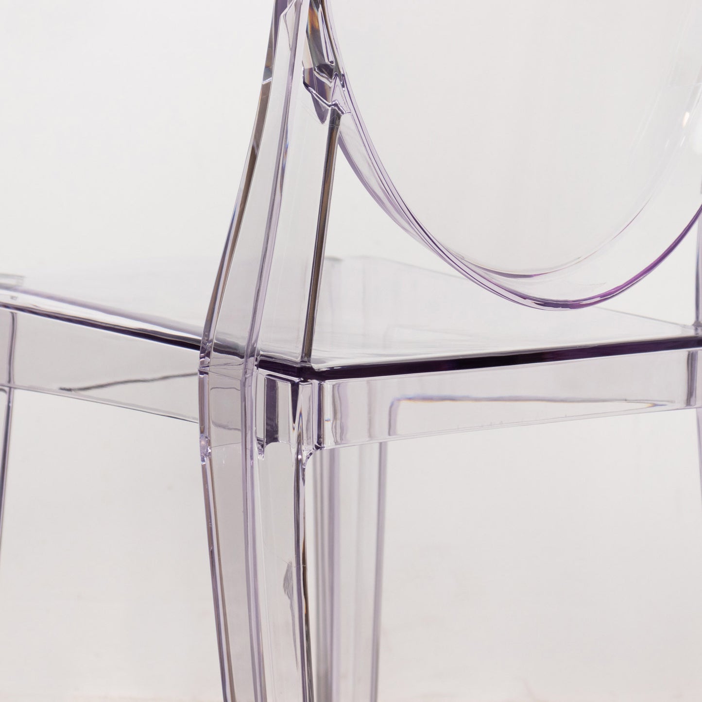 Clear acrylic ghost banquet chair with oval back, fully assembled.