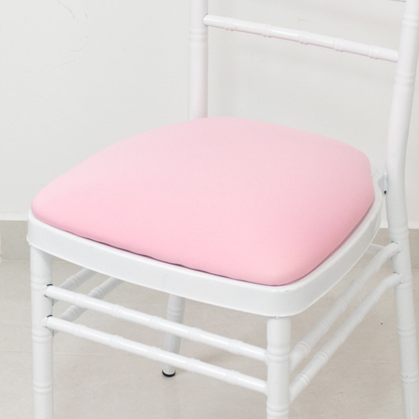 Pink spandex slipcover for Chiavari chair seat pad.