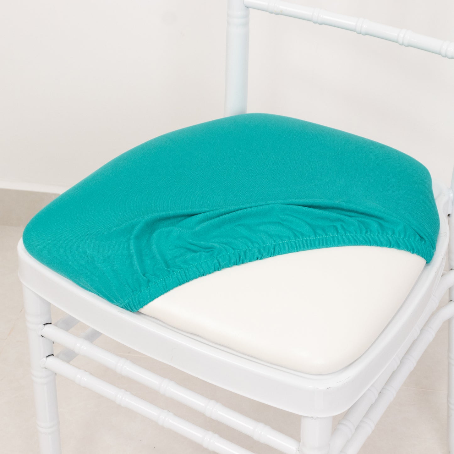 Turquoise spandex seat pad slipcover for Chiavari chair.