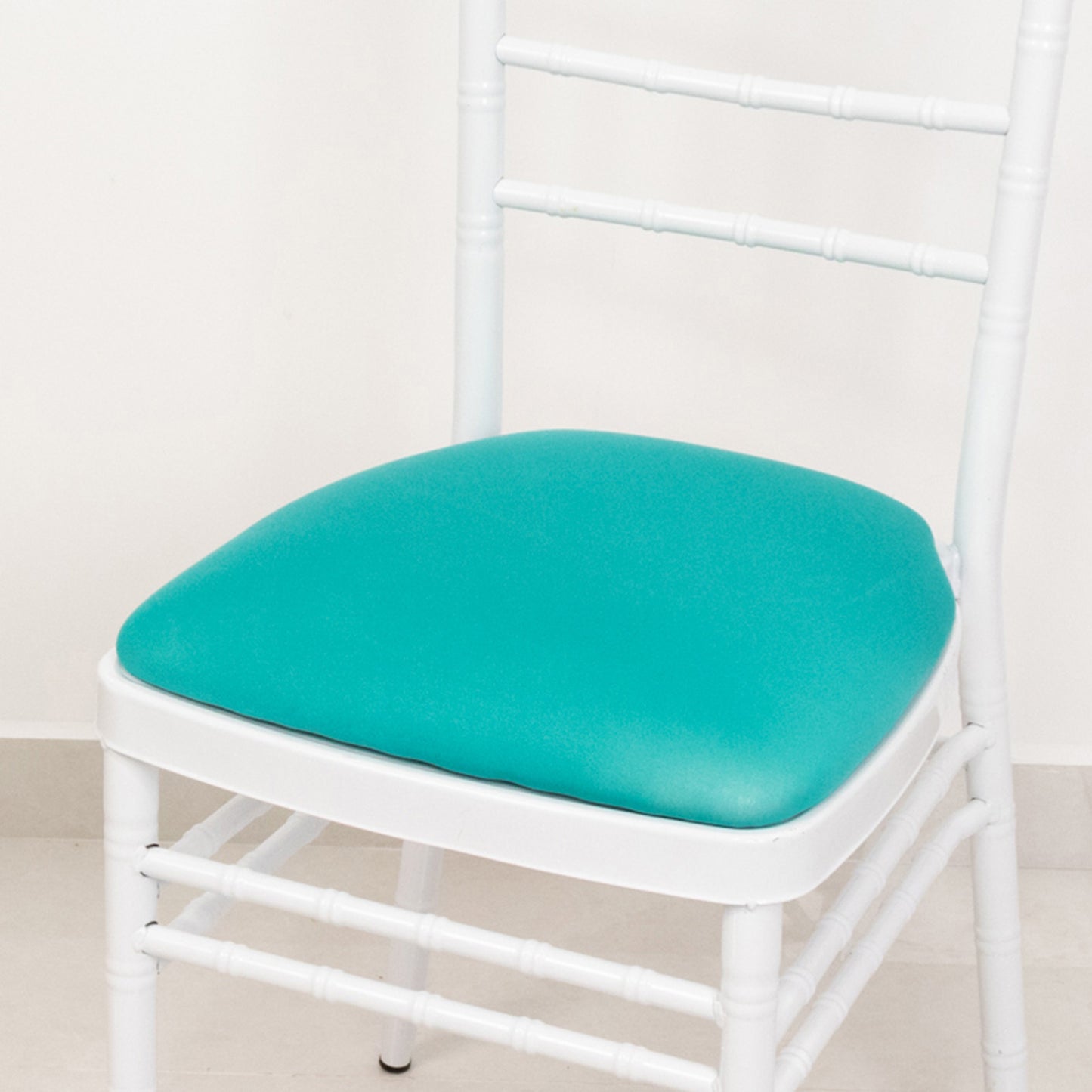 Turquoise spandex slipcover for Chiavari chair seat pad.