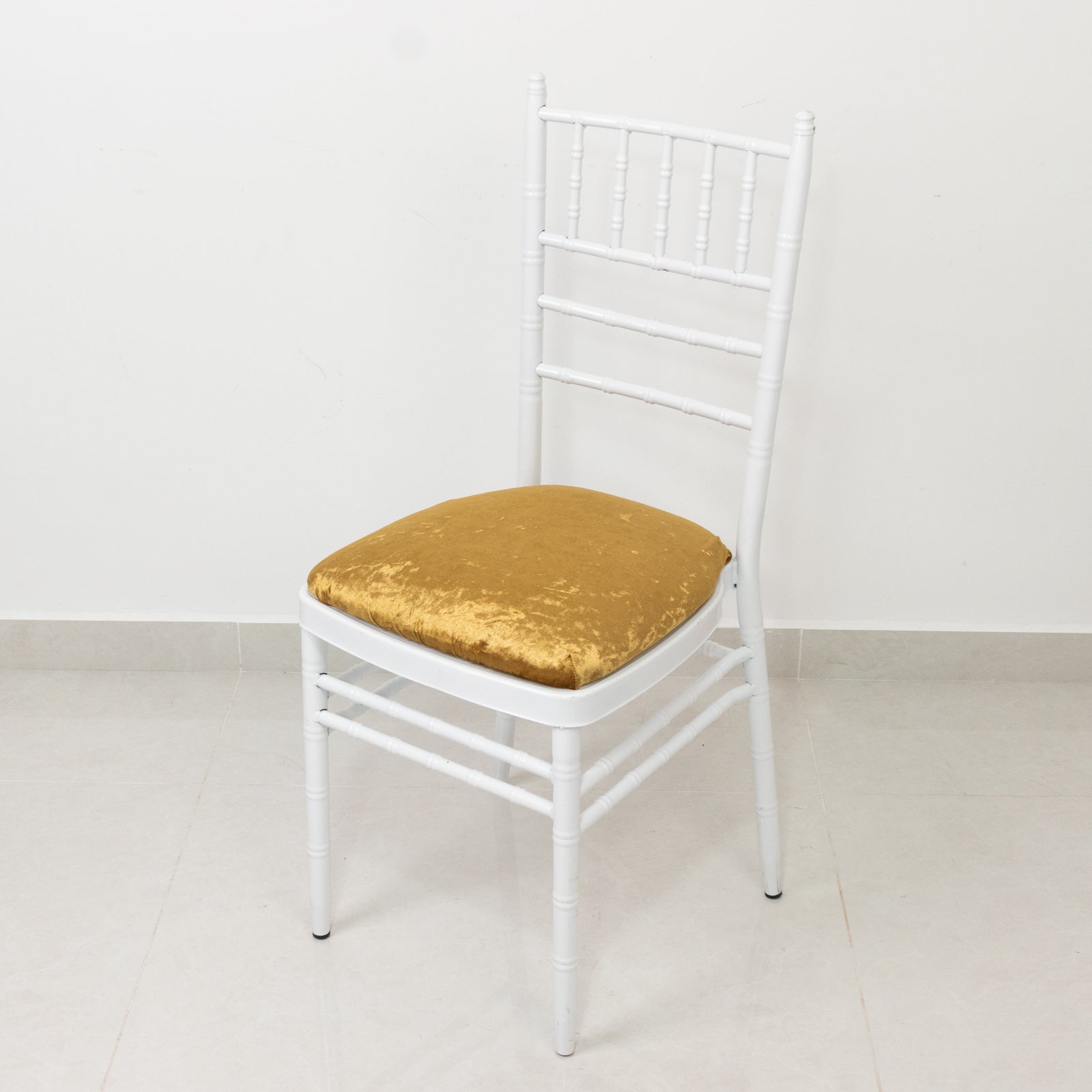 Gold crushed velvet seat pad cover on a Chiavari chair.