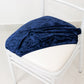 Navy blue crushed velvet seat pad cover on a Chiavari chair.