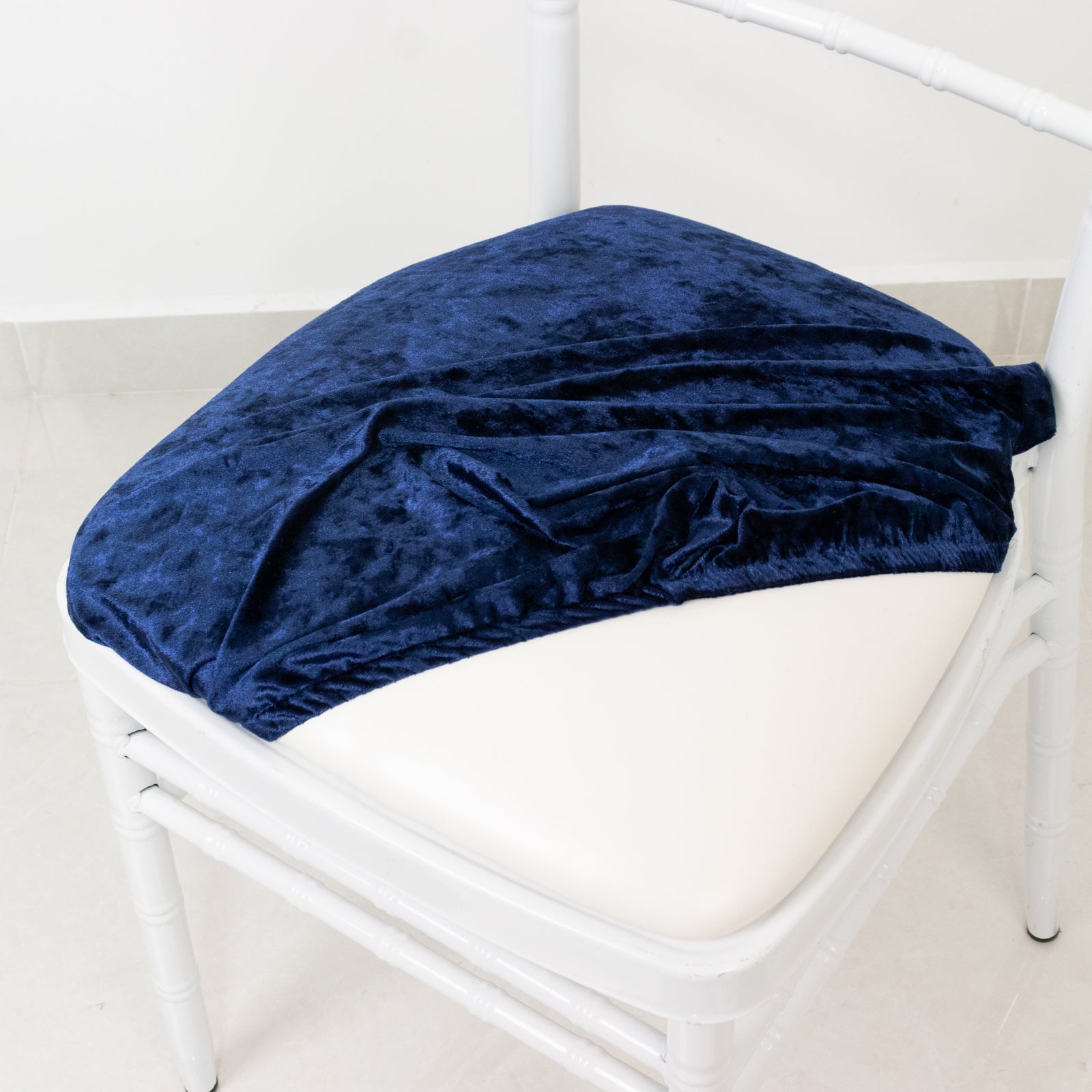 Navy blue crushed velvet seat pad cover on a Chiavari chair.