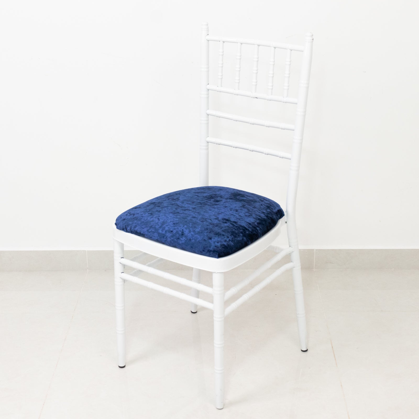 Navy blue crushed velvet seat pad cover on a Chiavari chair.