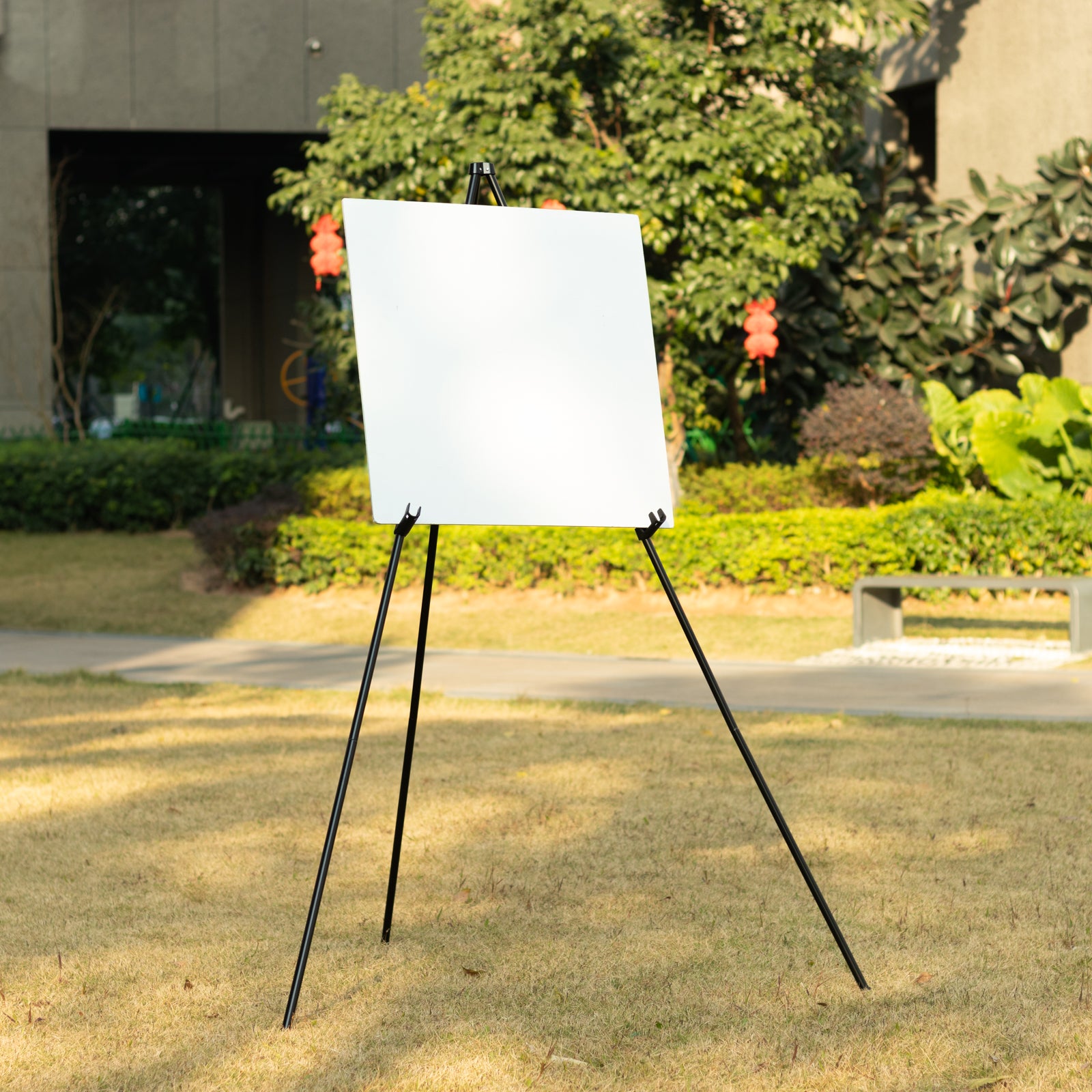 Black metal easel stand for displaying signs and art outdoors.