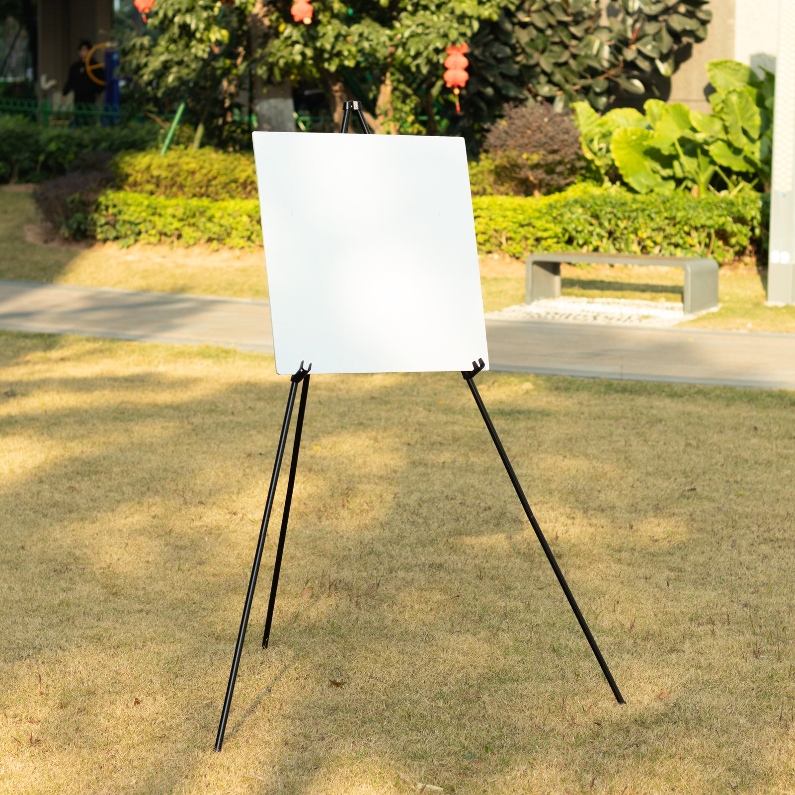 Black metal easel stand for wedding signs and art.