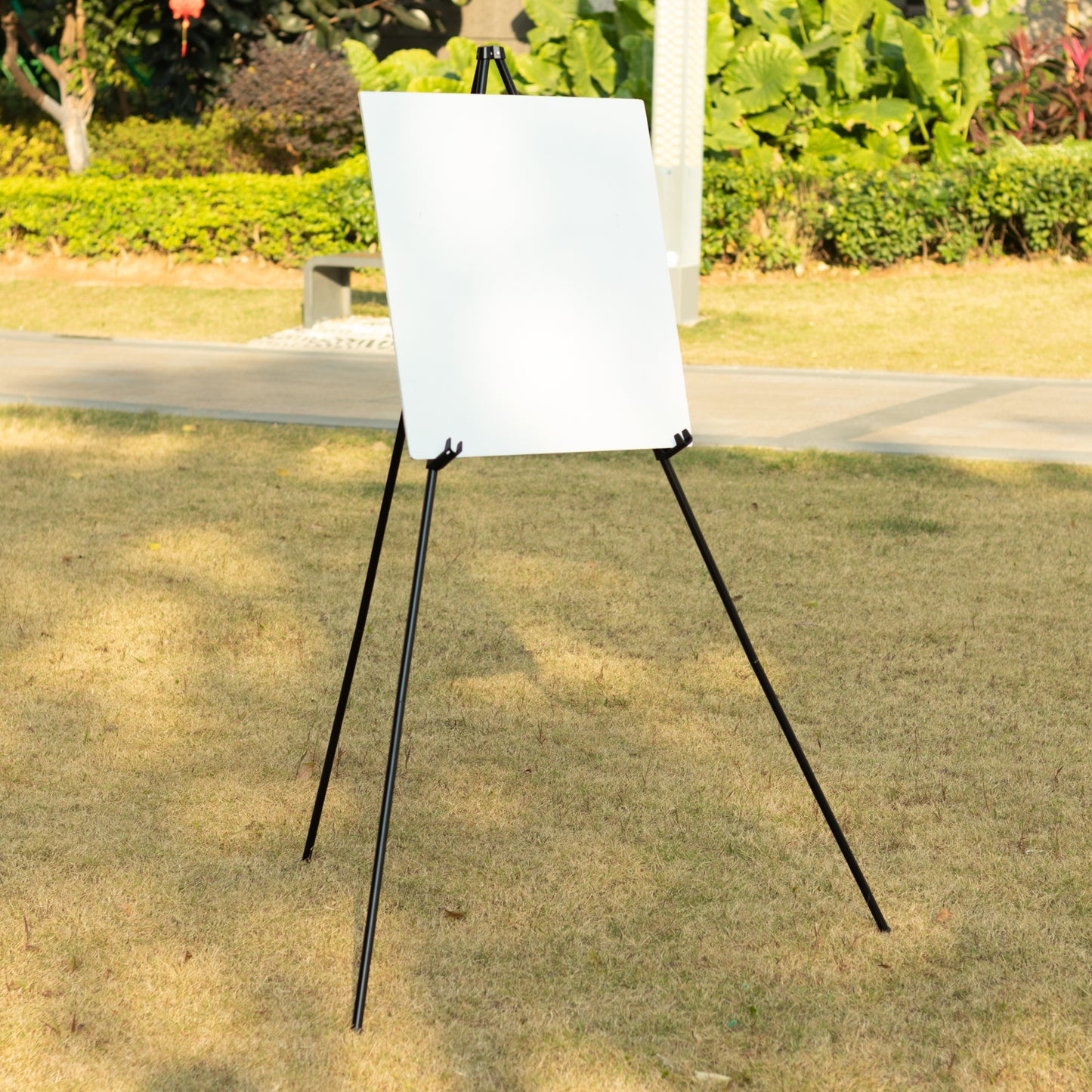 Black metal easel stand for displaying wedding signs and art.