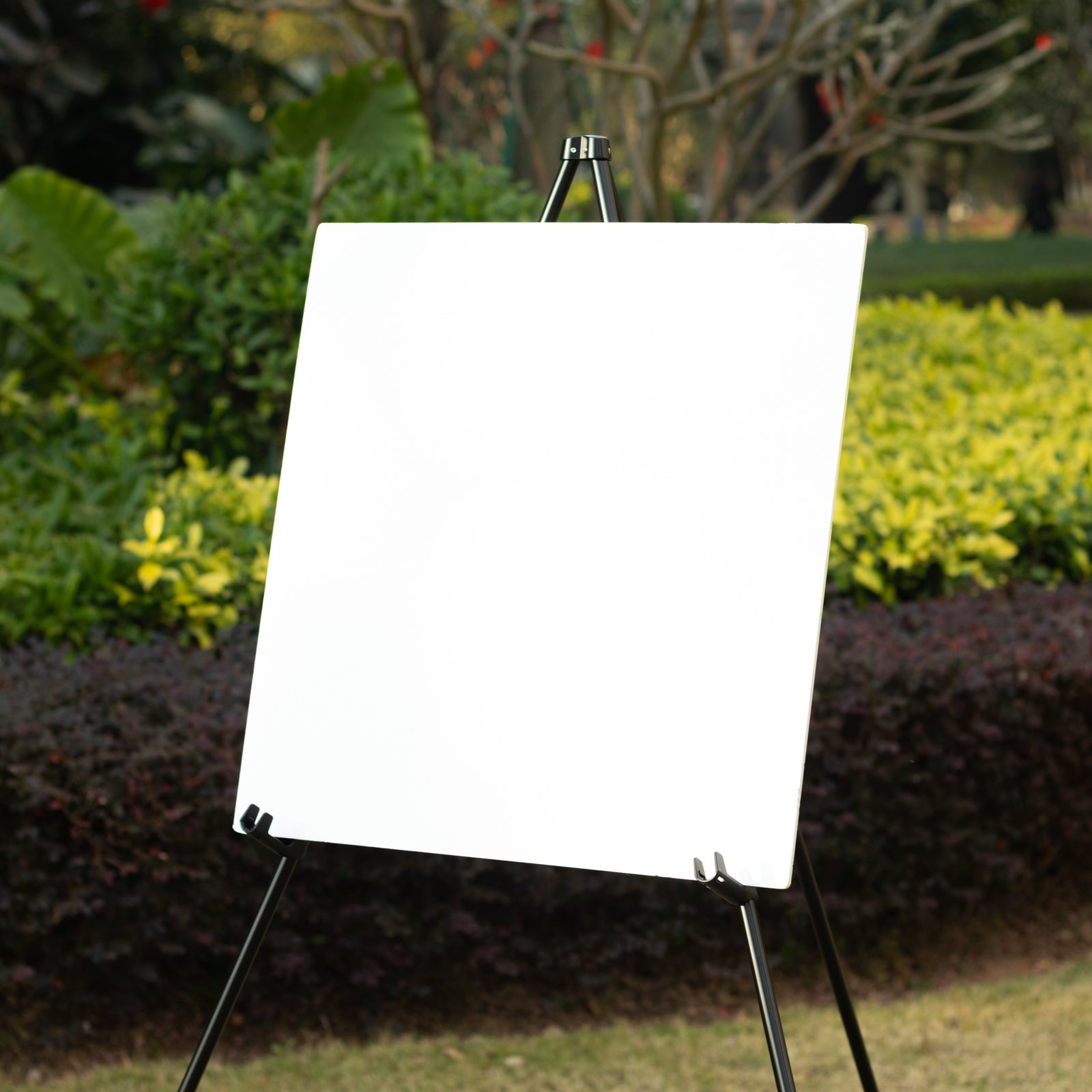 Black metal easel stand for displaying signs and posters outdoors.
