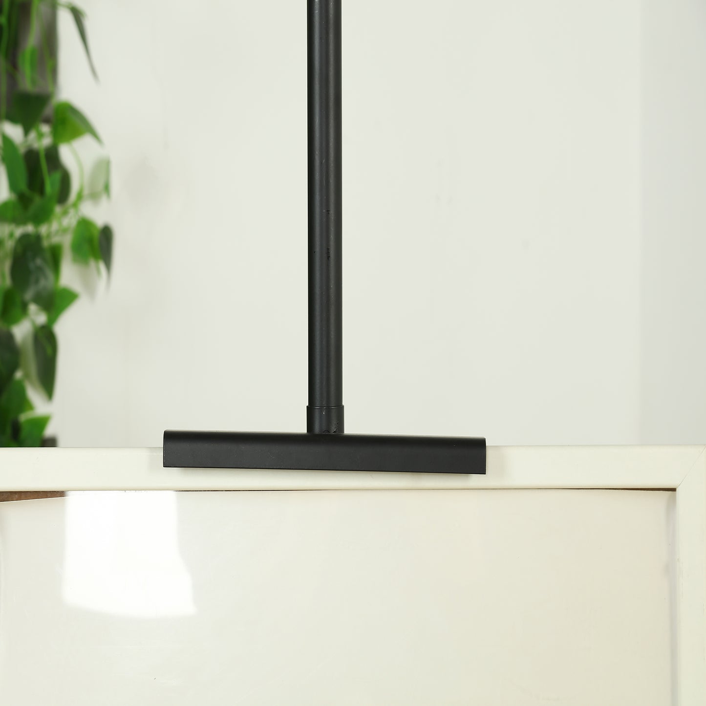 Black metal painting display easel stand adjustable for frames and artwork.