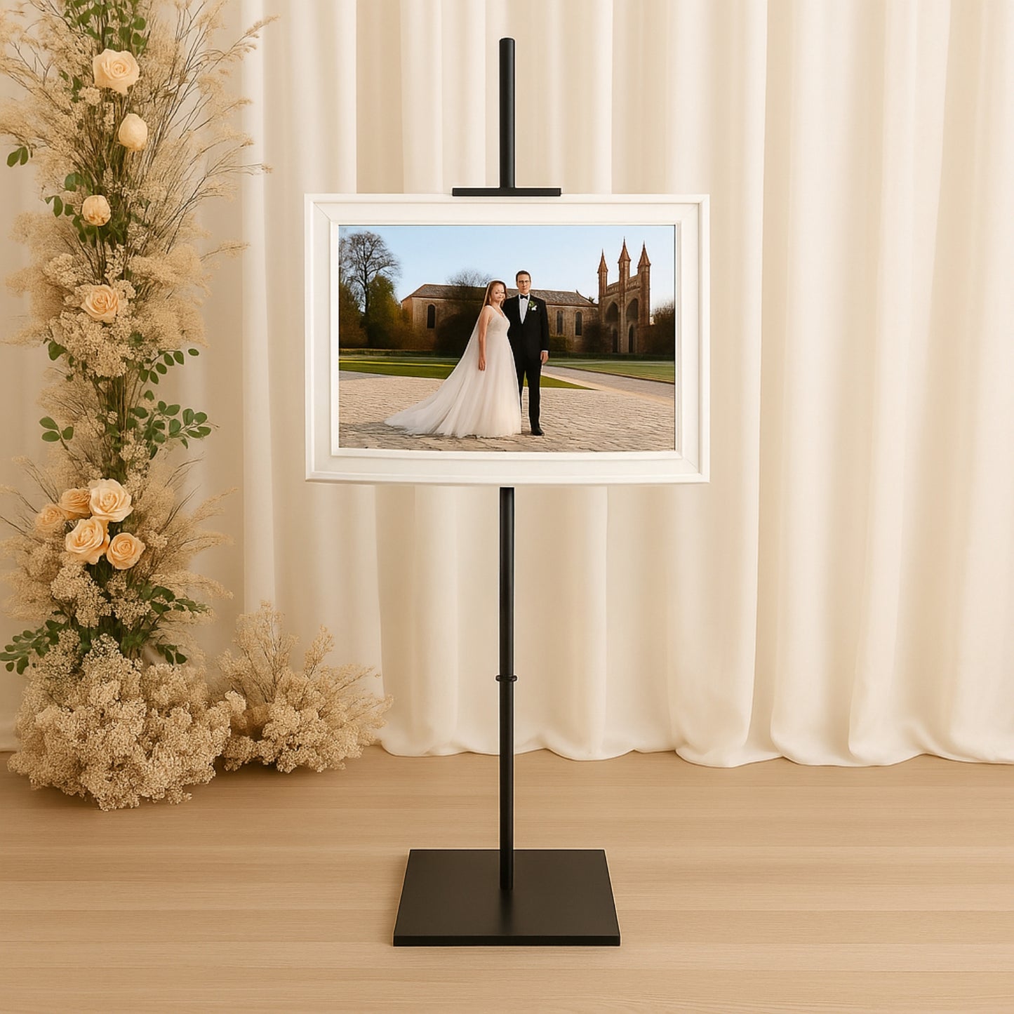 Black metal easel stand for displaying artwork and frames.