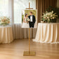 Gold easel stand for displaying artwork and frames in a stylish setting.