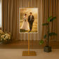 Gold easel stand displaying a framed artwork in a stylish setting.