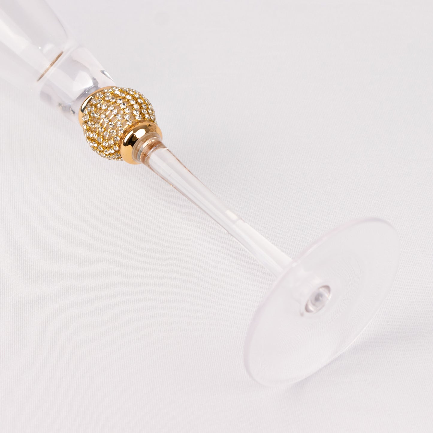 Gold rim crystal champagne flute with studded diamond rhinestones.