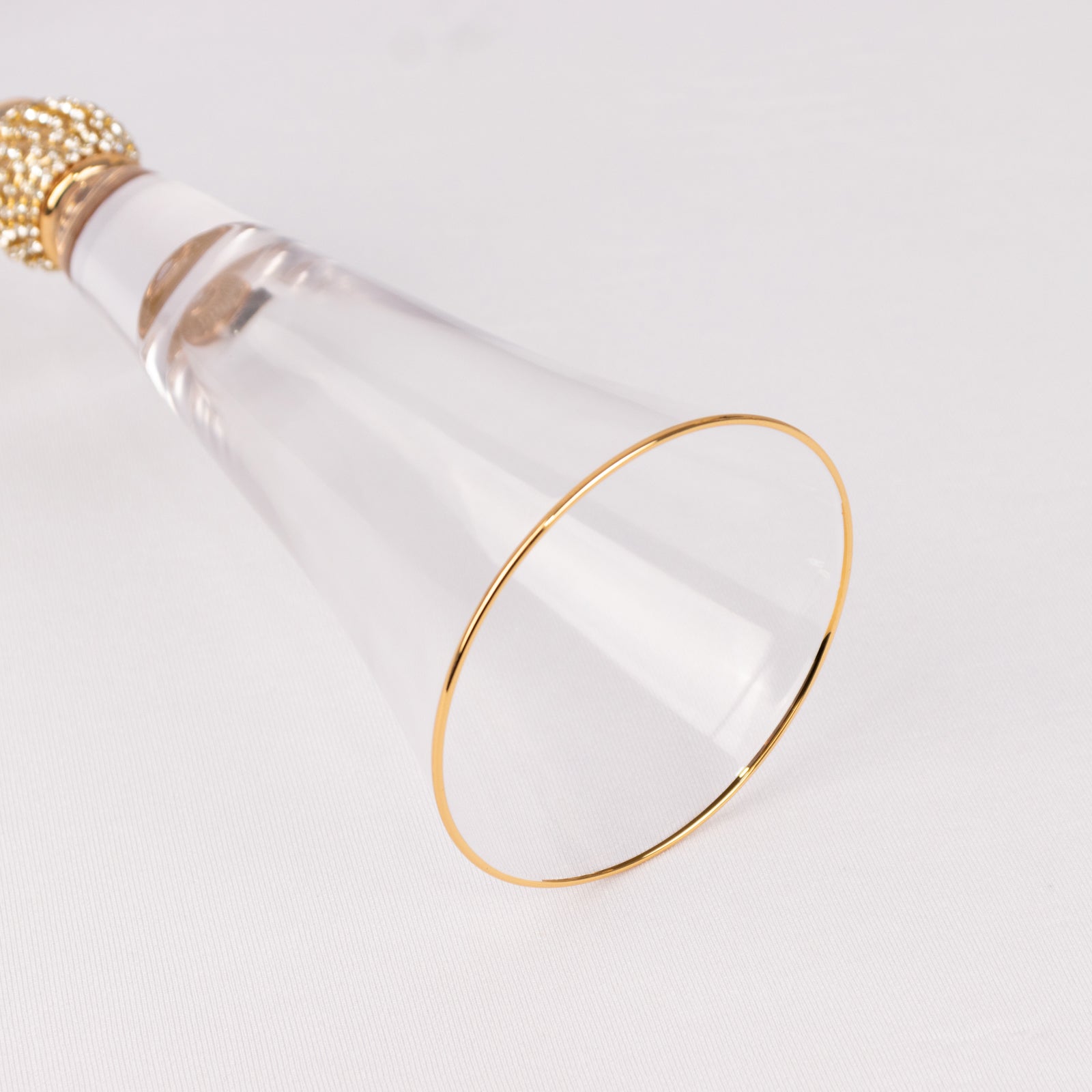 Gold rim crystal champagne flute glass with studded rhinestones.