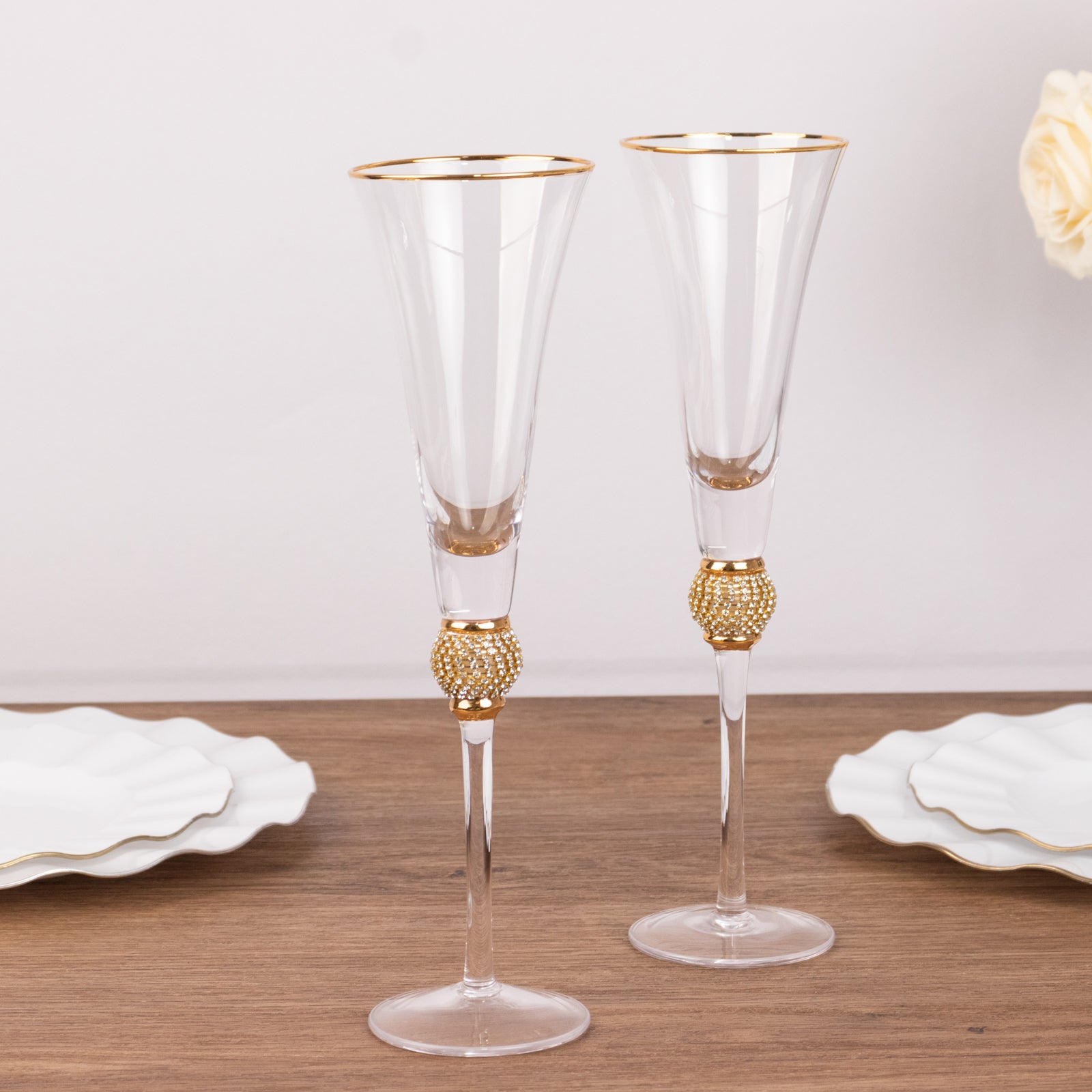 Gold rim crystal champagne flute glasses with studded rhinestones.