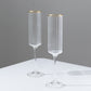 Clear modern champagne flutes with gold rim, elegant design for celebrations.