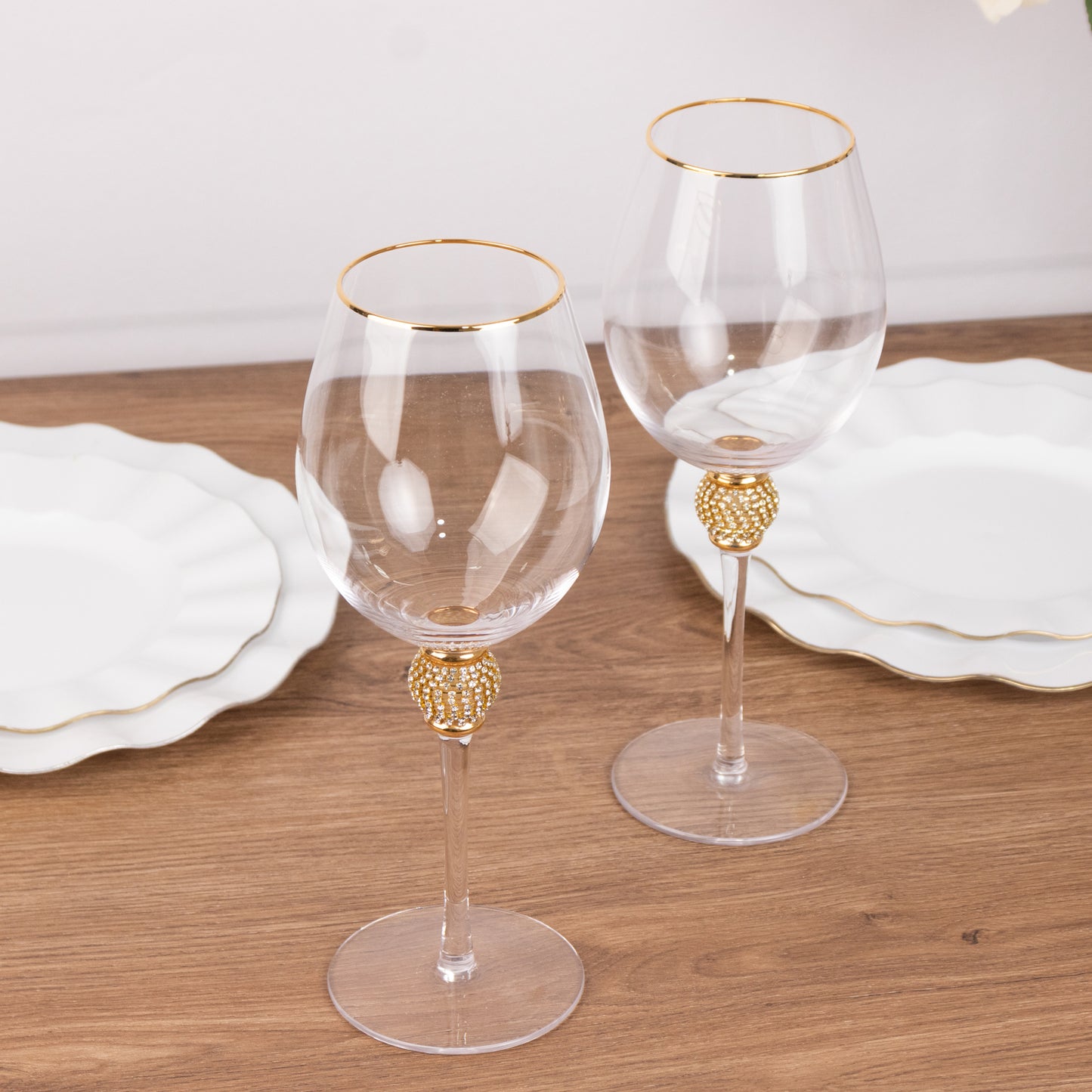 Gold rimmed crystal wine goblet glasses with rhinestone stems.