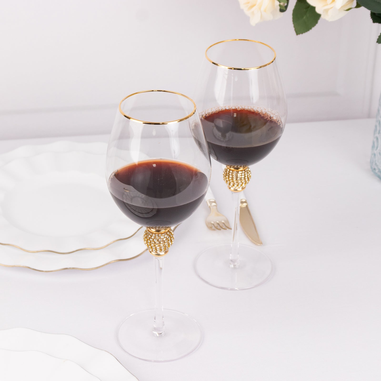 Gold rimmed crystal wine goblet glasses with rhinestone stem.
