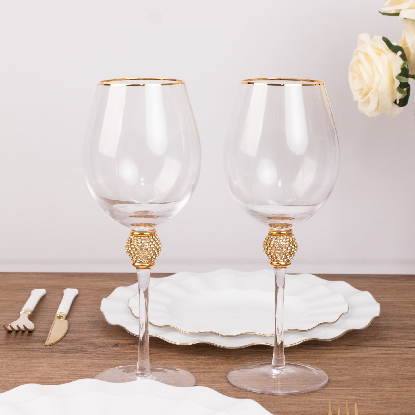Gold rimmed crystal wine goblet glasses with rhinestone stem.