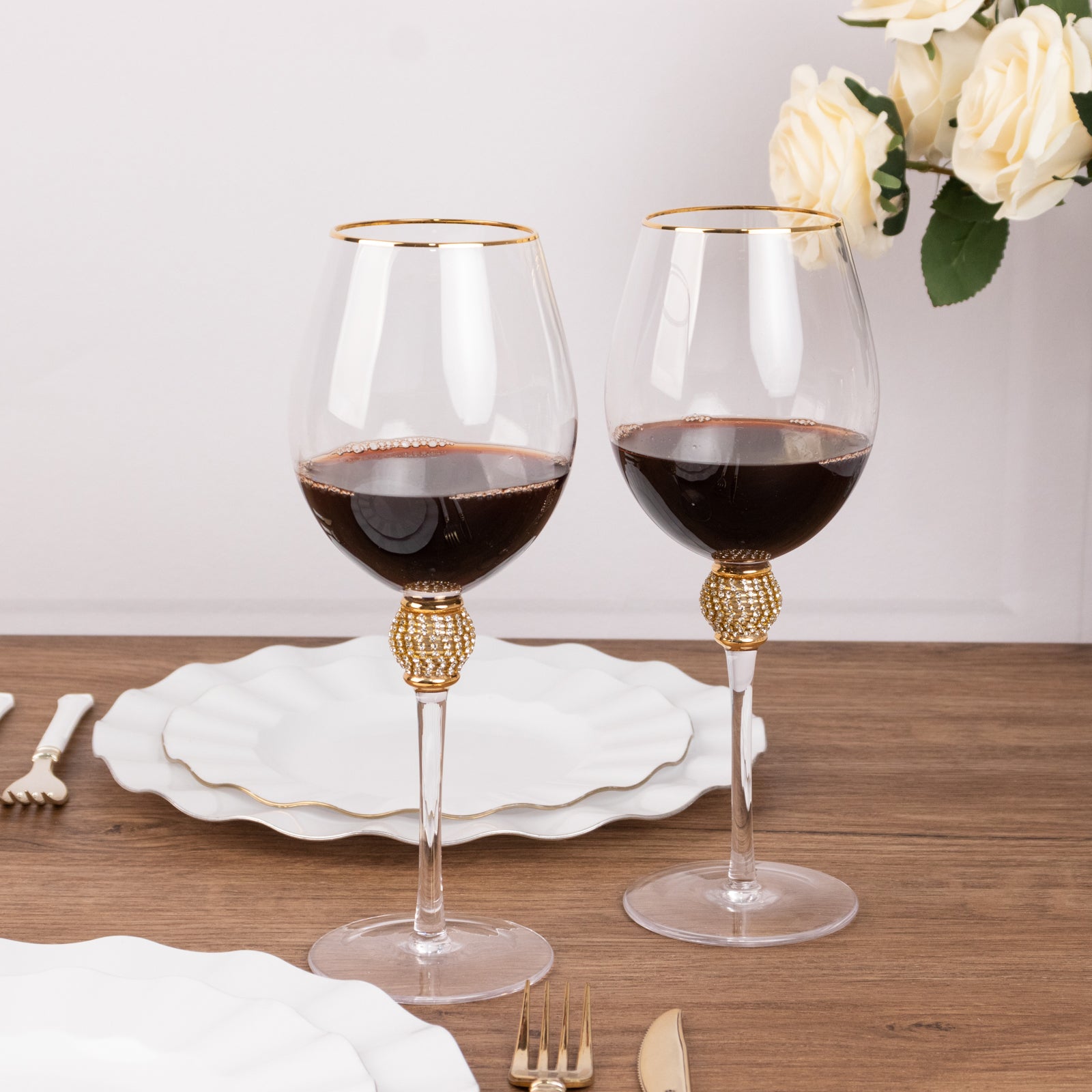 Gold rimmed crystal wine goblet glasses with rhinestone stems.