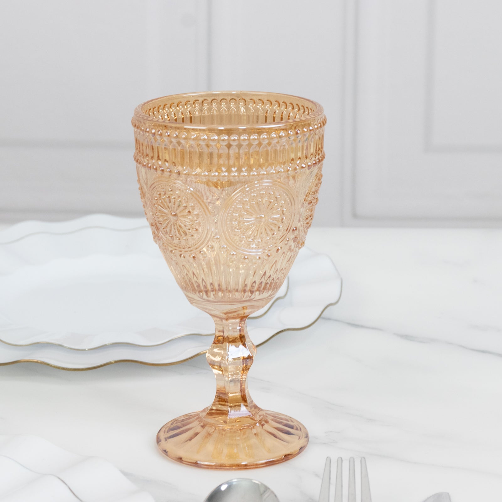 Amber gold vintage goblet with floral design, perfect for cocktails and wine.