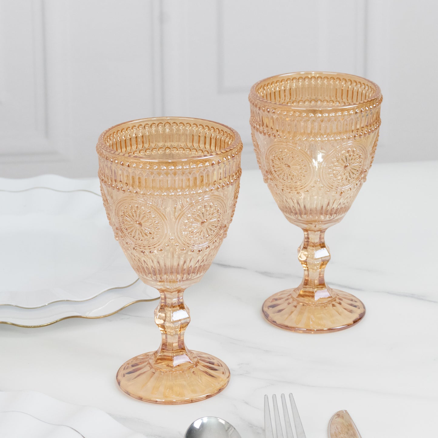 Amber vintage embossed goblets with floral design, perfect for cocktails and wine.