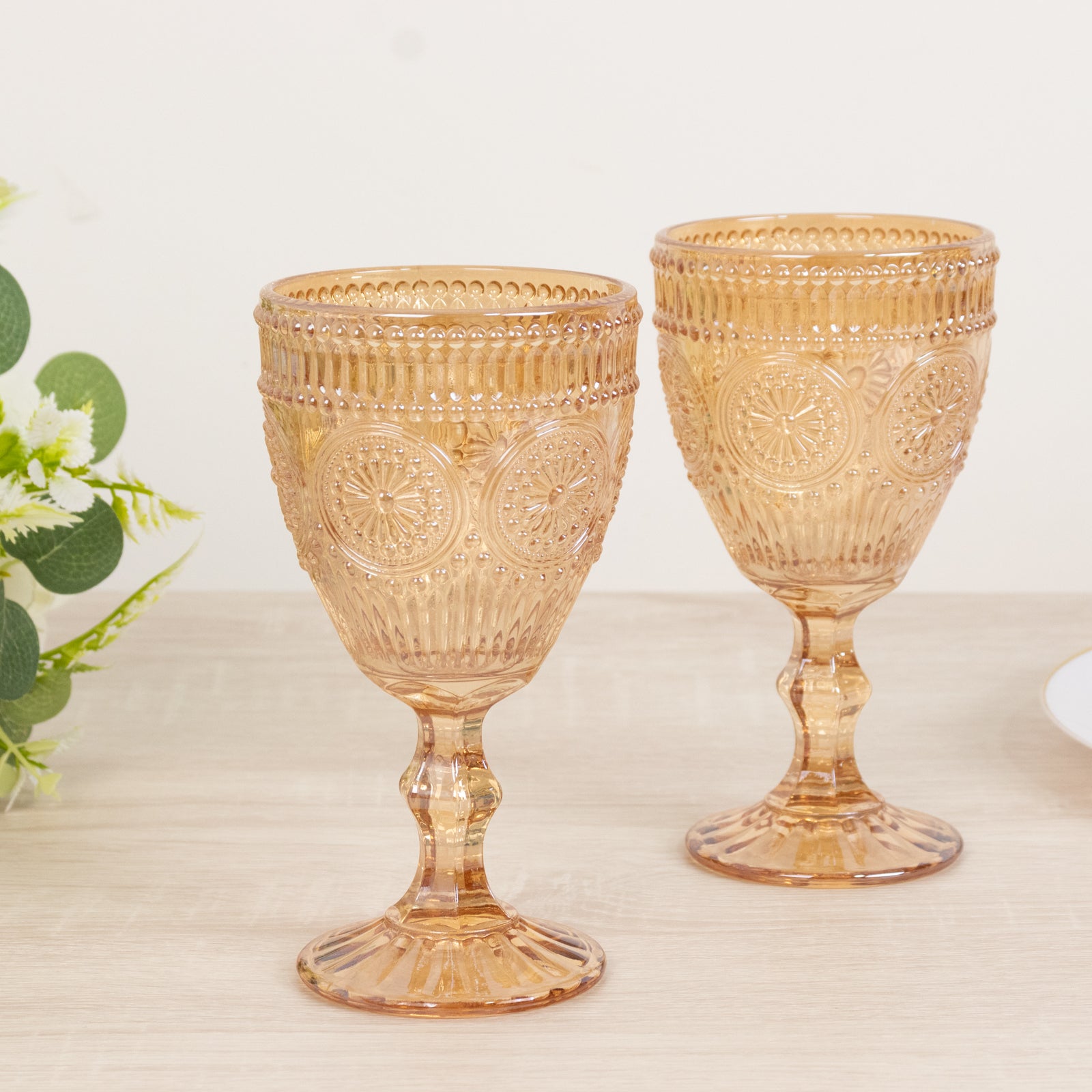 Amber gold vintage embossed goblets with floral design, perfect for cocktails or wine.