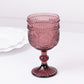 Dusty rose vintage embossed goblet wine glass with floral pattern.