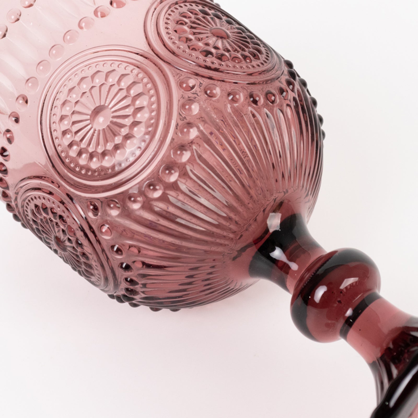Dusty rose vintage embossed goblet wine glass with floral pattern.